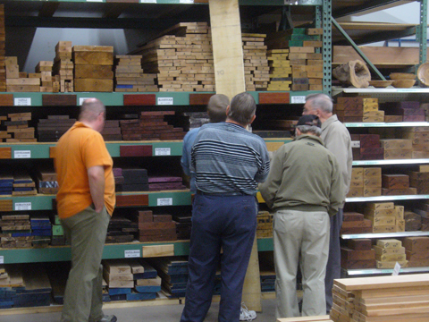 woodworkers sorting through wood