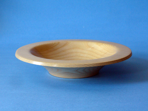 An Ash Bowl With A Flanged Rim